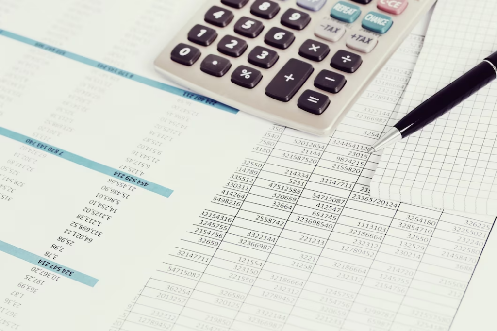 A calculator, pen, and financial report captured together.