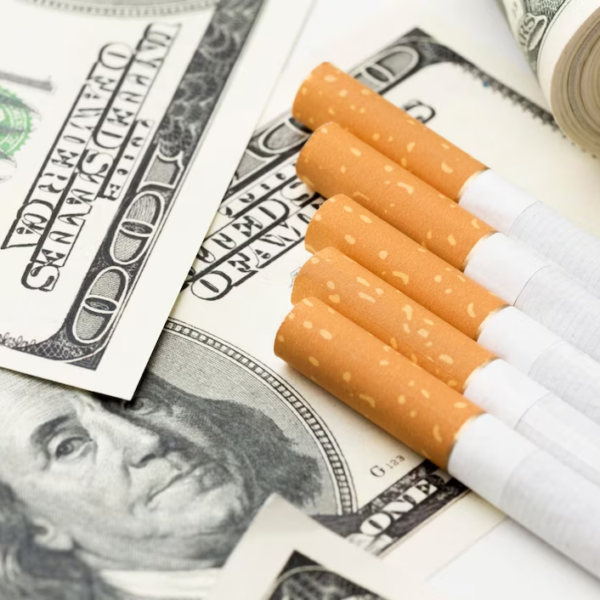 Cigarettes surrounded by dollar bills