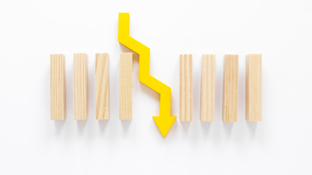 Arranged wooden blocks with a downward-facing yellow arrow in the center.