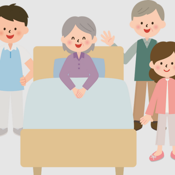 family next to an elderly woman's bed