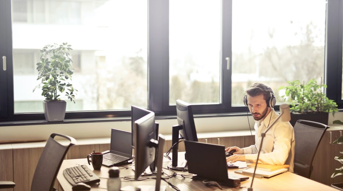 Man working on the computer at financial institution.