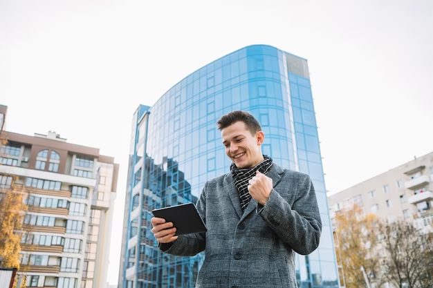 Man holding a tablet in front of the house